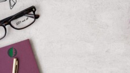 glasses and notebook on desk