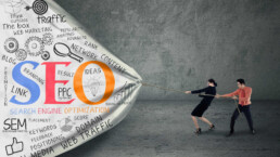 graphic of man and woman pulling a big heavy bag filled with SEO terms