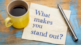 coffee cup and paper that says what makes you stand out